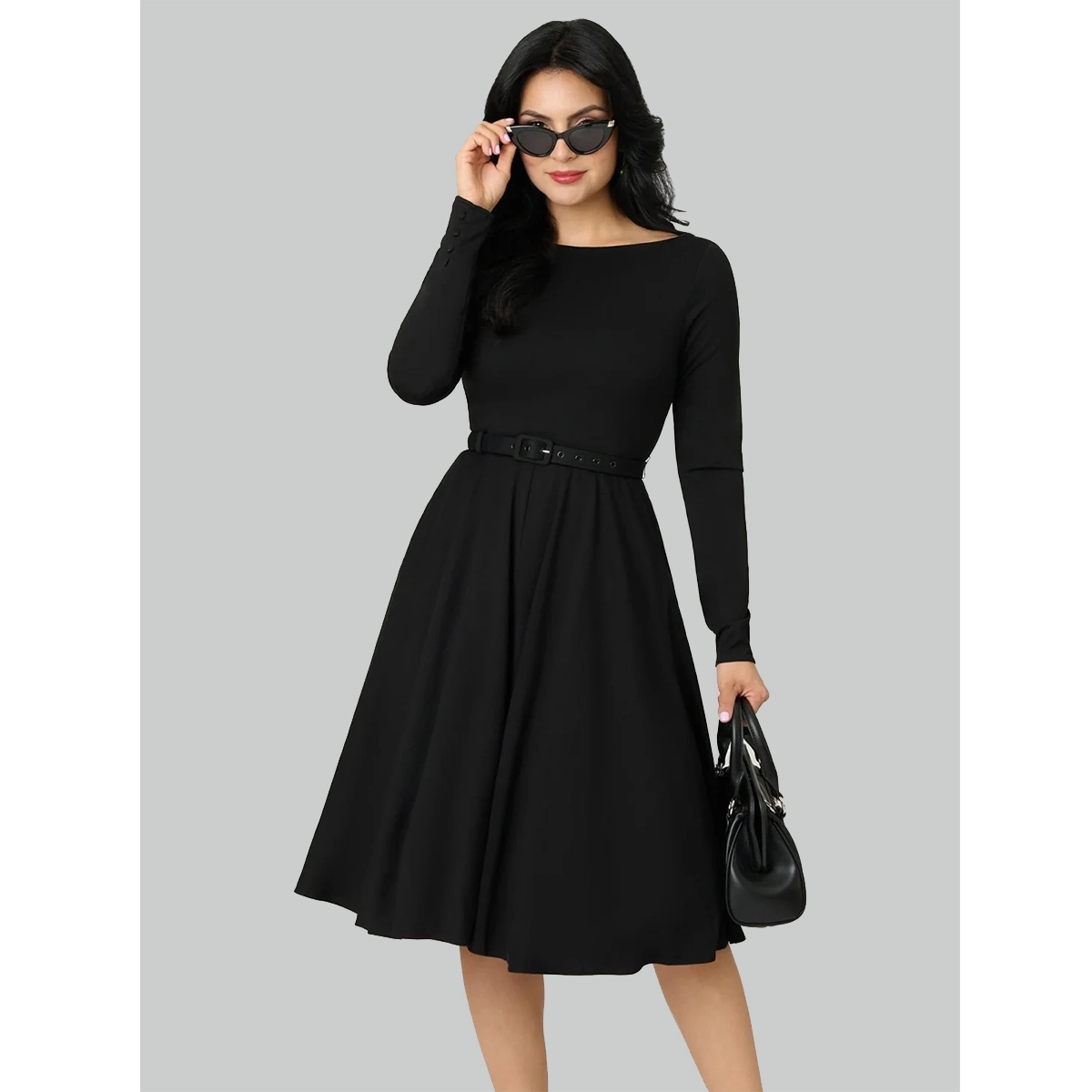 vintage black dress with long sleeves 1950s inspired silhouette matching belt and swing skirt