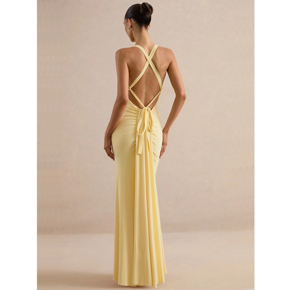 yellow backless party dress with halter neckline crossed back detail open back fishtail maxi length silhouette