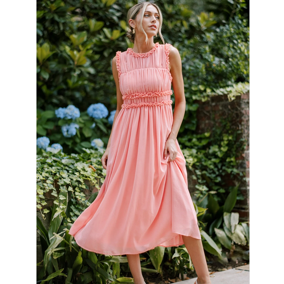 pink sleeveless midi dress with ruffled round neck tiered frilled waist seams and a line skirt