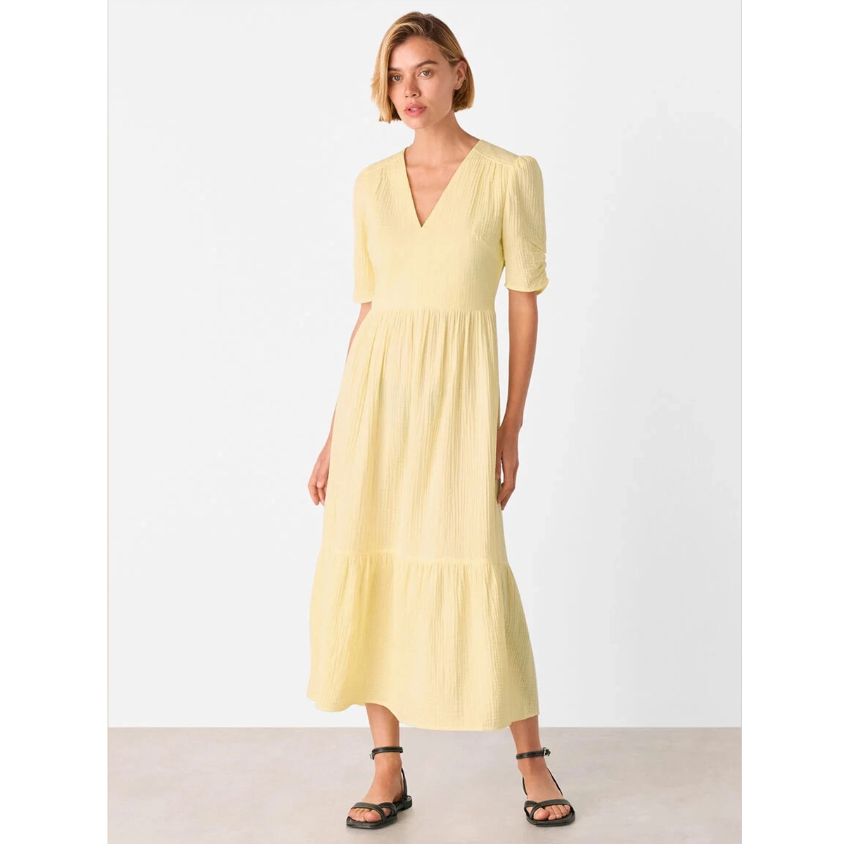 yellow textured cotton midi dress with ruched short sleeves v neckline fitted waist and tiered hem