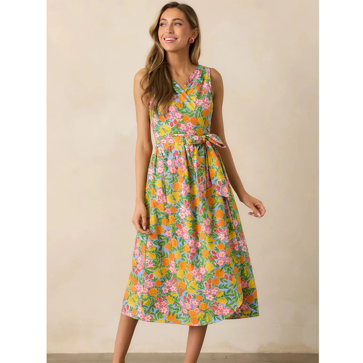 floral printed wrap dress surplice neckline sleeveless self tie waist belt hip pockets flowing silhouette casual dress