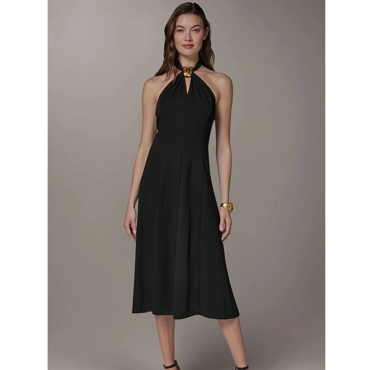 black sleeveless halter dress with keyhole front gold napkin ring detail a line midi length elegant style