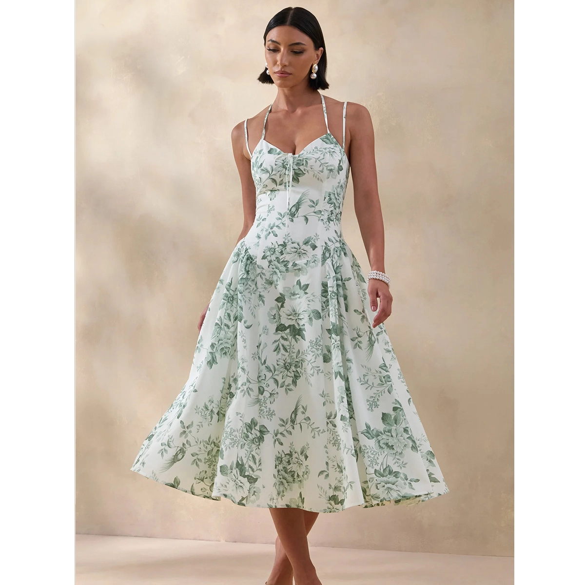 green floral print midi dress with sweetheart neckline bow detail and ruching detail
