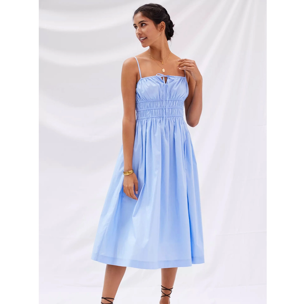 blue floral smocked midi dress with adjustable spaghetti straps and flowy skirt